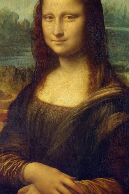 Detail: the Mona Lisa's head, shoulders and hands, showing the spiralling turn of the pose and the landscape at the top of the frame