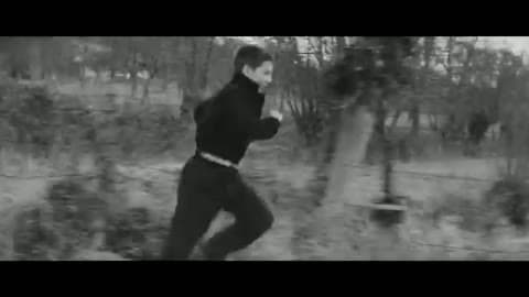 Young Jean-Pierre Léaud as Antoine Doinel running along a country path in a dark sweater, the background streaked with motion, in black and white