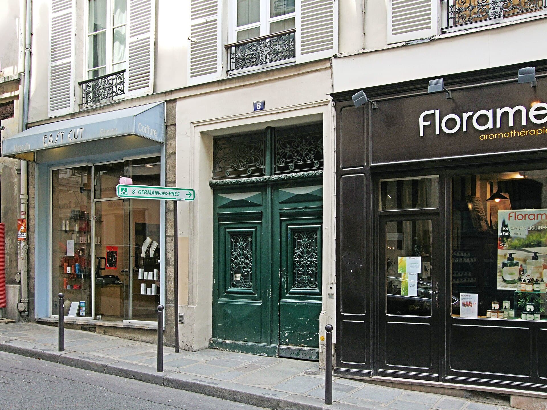 The narrow shopfront at 8 rue Dupuytren, Paris, photographed in 2013 — the number 8 above a green double door