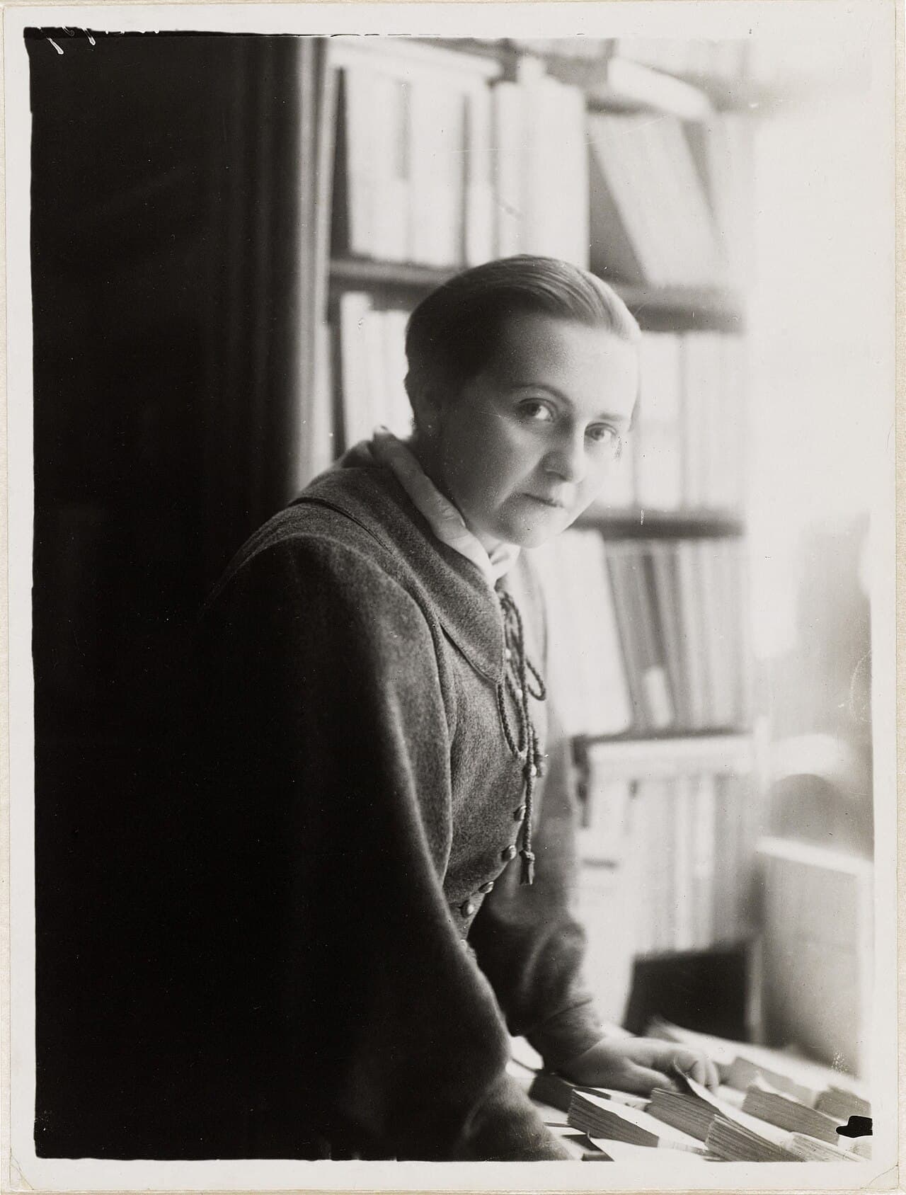 Adrienne Monnier in La Maison des Amis des Livres, photographed by Henri Manuel around 1925.