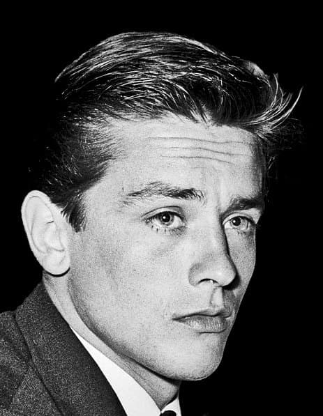 Twenty-six-year-old Alain Delon looking directly at the camera in a black-and-white 1961 portrait