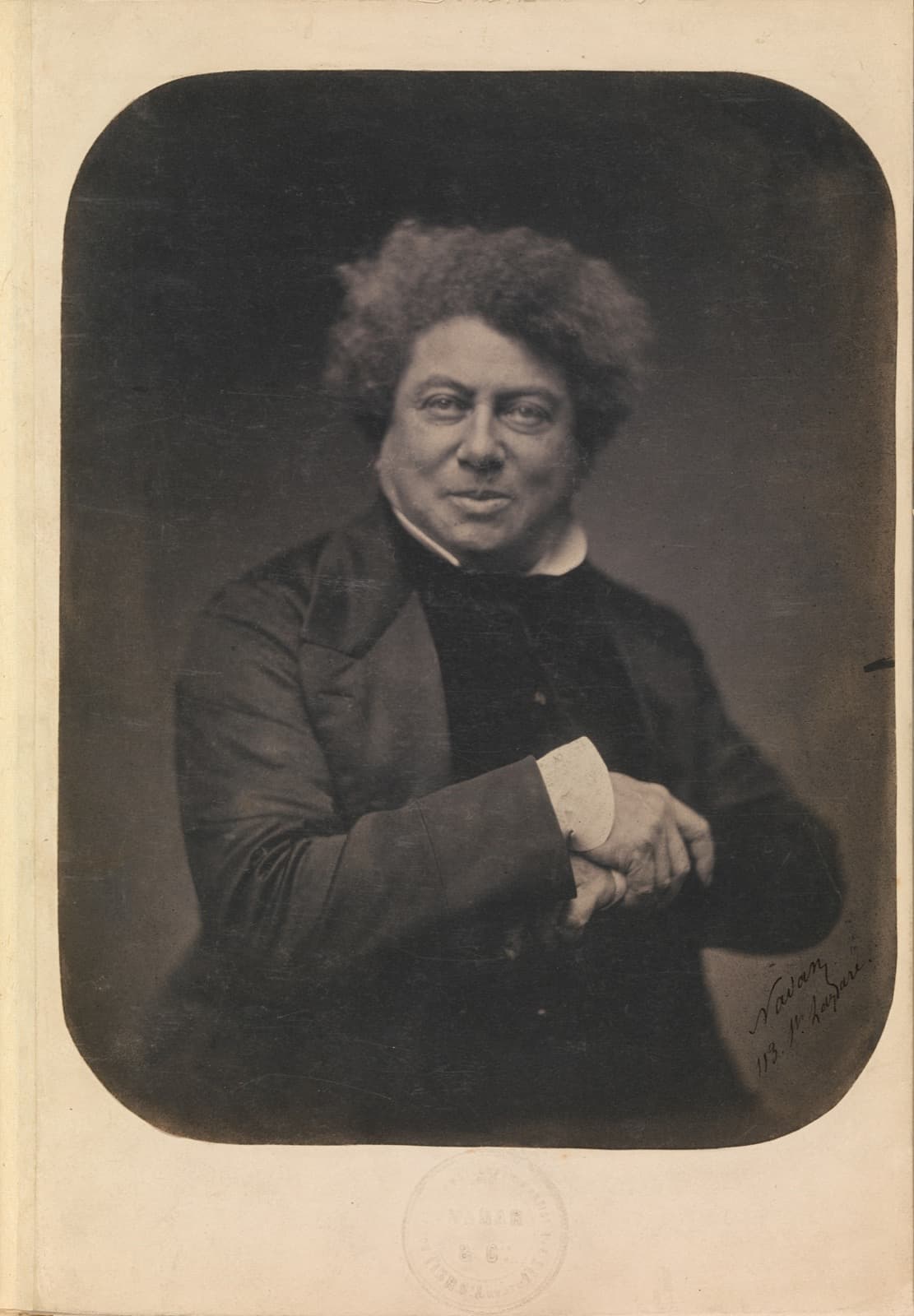 Alexandre Dumas seated with his hands folded over a cane in Nadar's 1855 portrait