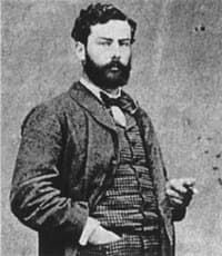 Alfred Sisley standing with a dark beard, in a small photograph from 1882.