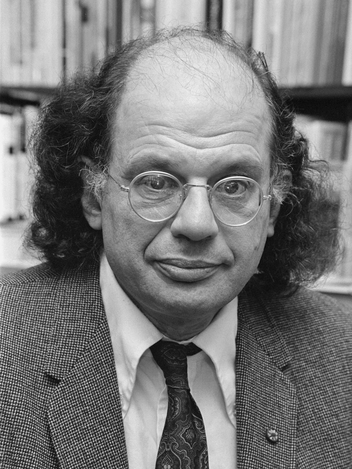 Allen Ginsberg in 1979, bearded and wearing a jacket and tie