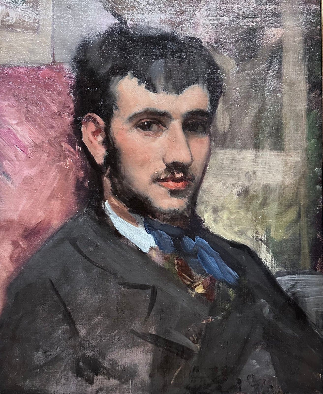 Bazille's portrait of the young Renoir seated with his knees drawn up on a chair, looking to the left
