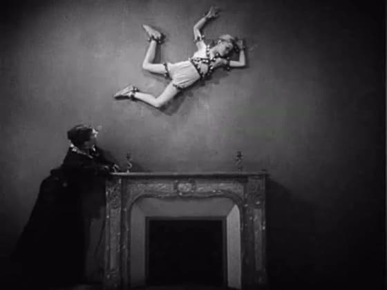 A keyhole room in The Blood of a Poet, with a child suspended near the ceiling