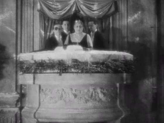 Elegant spectators in theater boxes watching the final card game in The Blood of a Poet