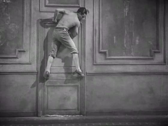 The Poet crawling sideways along the rotated hotel corridor in The Blood of a Poet