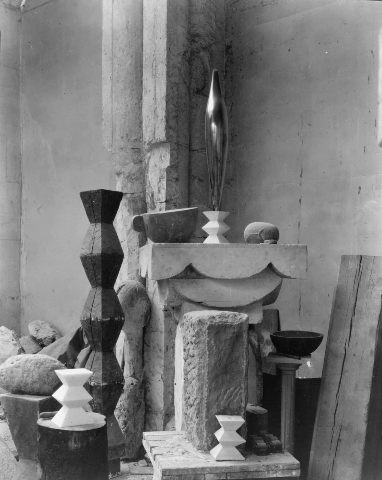 Brancusi's Paris studio photographed in 1920, plaster and stone sculptures arranged together