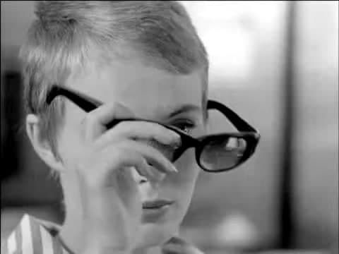 Jean Seberg as Patricia Franchini in Breathless, lifting large black sunglasses away from her eyes