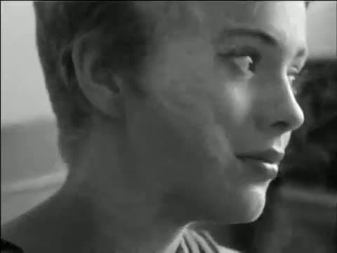 Close black-and-white profile of Jean Seberg with cropped hair