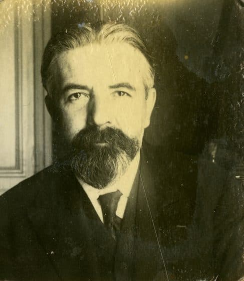 Head-and-shoulders portrait of Camille Lefèvre, bearded, in a dark suit and tie.