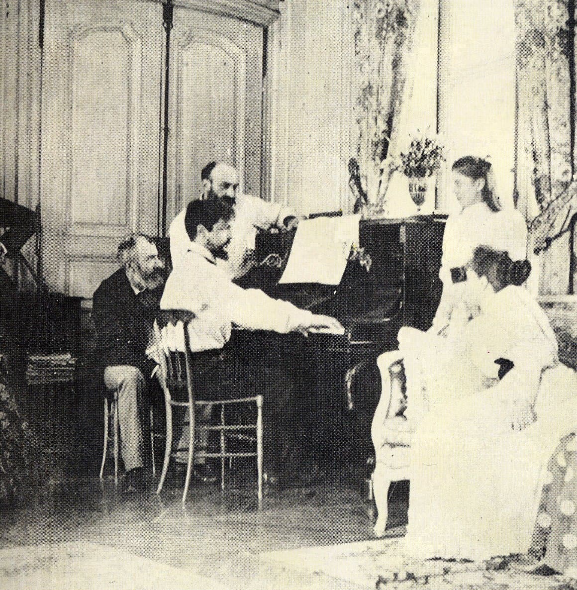 Claude Debussy seated outdoors with friends in 1893