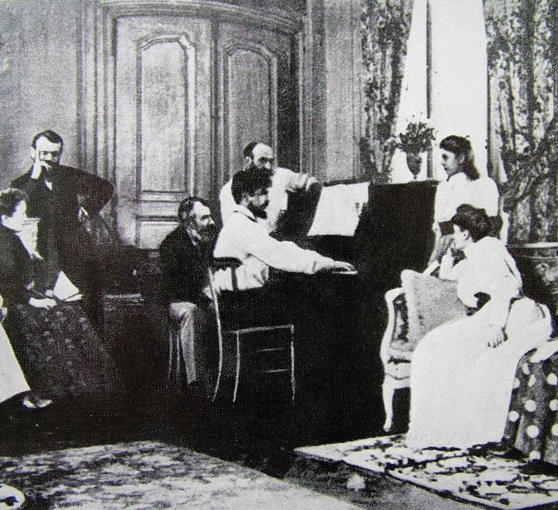 Claude Debussy seated at the piano in Ernest Chausson's salon in 1893