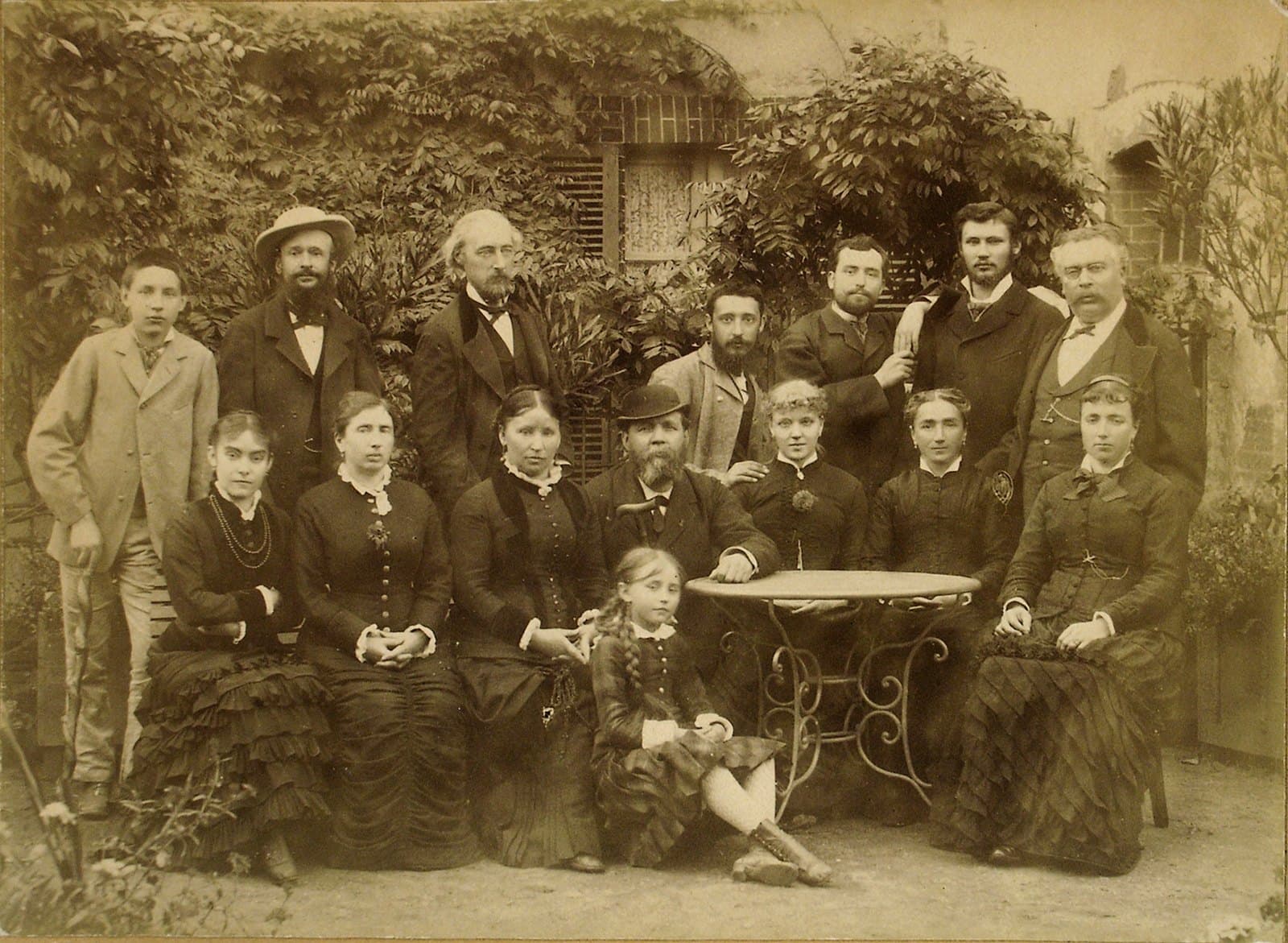 Colette as a child seated with her parents and siblings around 1880
