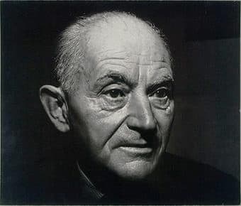 Daniel-Henry Kahnweiler in close-up at seventy-one, half his face in shadow.
