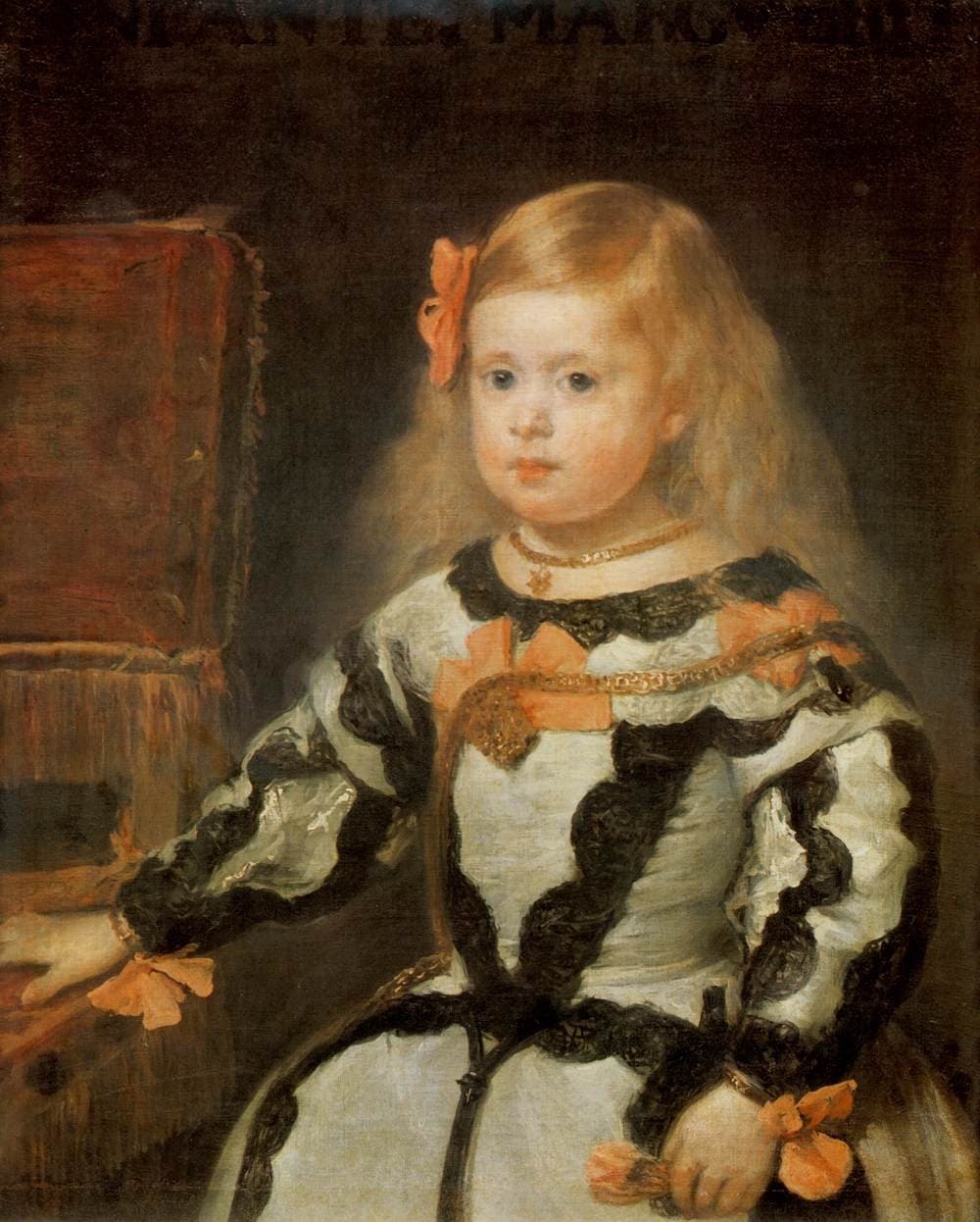 A half-length portrait of a small girl of about three against a dark background. She has fair hair parted in the middle and pinned with a red bow, round pale cheeks, and a serious expression. Her stiff pale dress has a wide collar and is trimmed with black lace and dark bands, and a chain hangs across her chest.