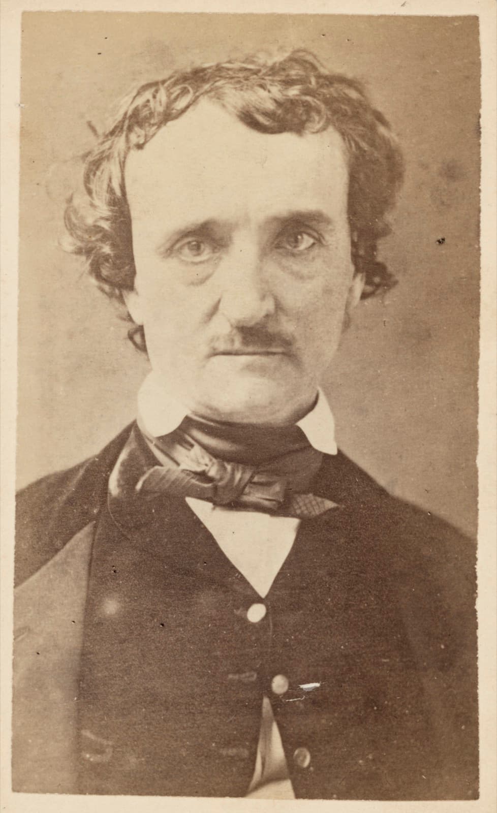 Edgar Allan Poe in a dark coat and cravat, his face turned slightly toward the camera in an albumen portrait made from a late daguerreotype