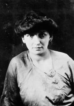 Fernande Olivier in 1906, dark hair swept up, hoop earrings, in a satin blouse.