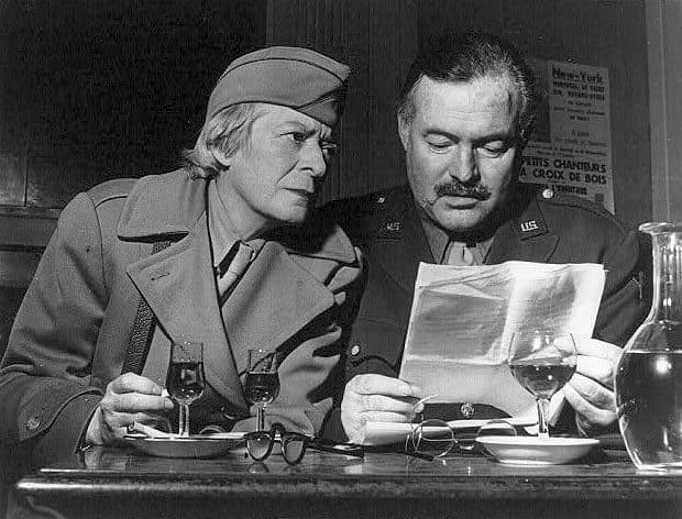 Ernest Hemingway in uniform with Janet Flanner at Les Deux Magots, Paris, 1944