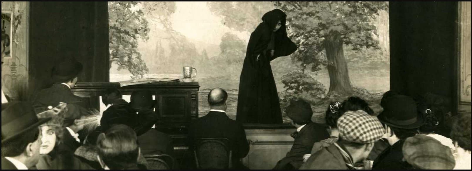 Irma Vep performing at the Chat-Huant cabaret in a wide still from Le Maître de la foudre, 1916