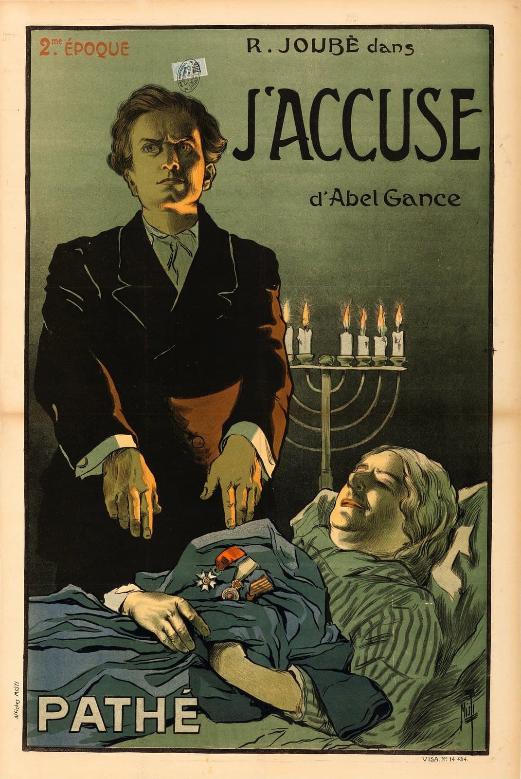 Color French poster for J'accuse: a standing man in black spreading his hands over a decorated soldier lying in bed, a lit candelabrum behind