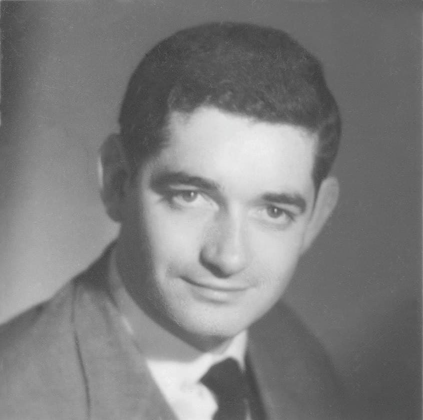Jacques Demy at twenty-five in an identity photograph, dark-haired in jacket and tie.