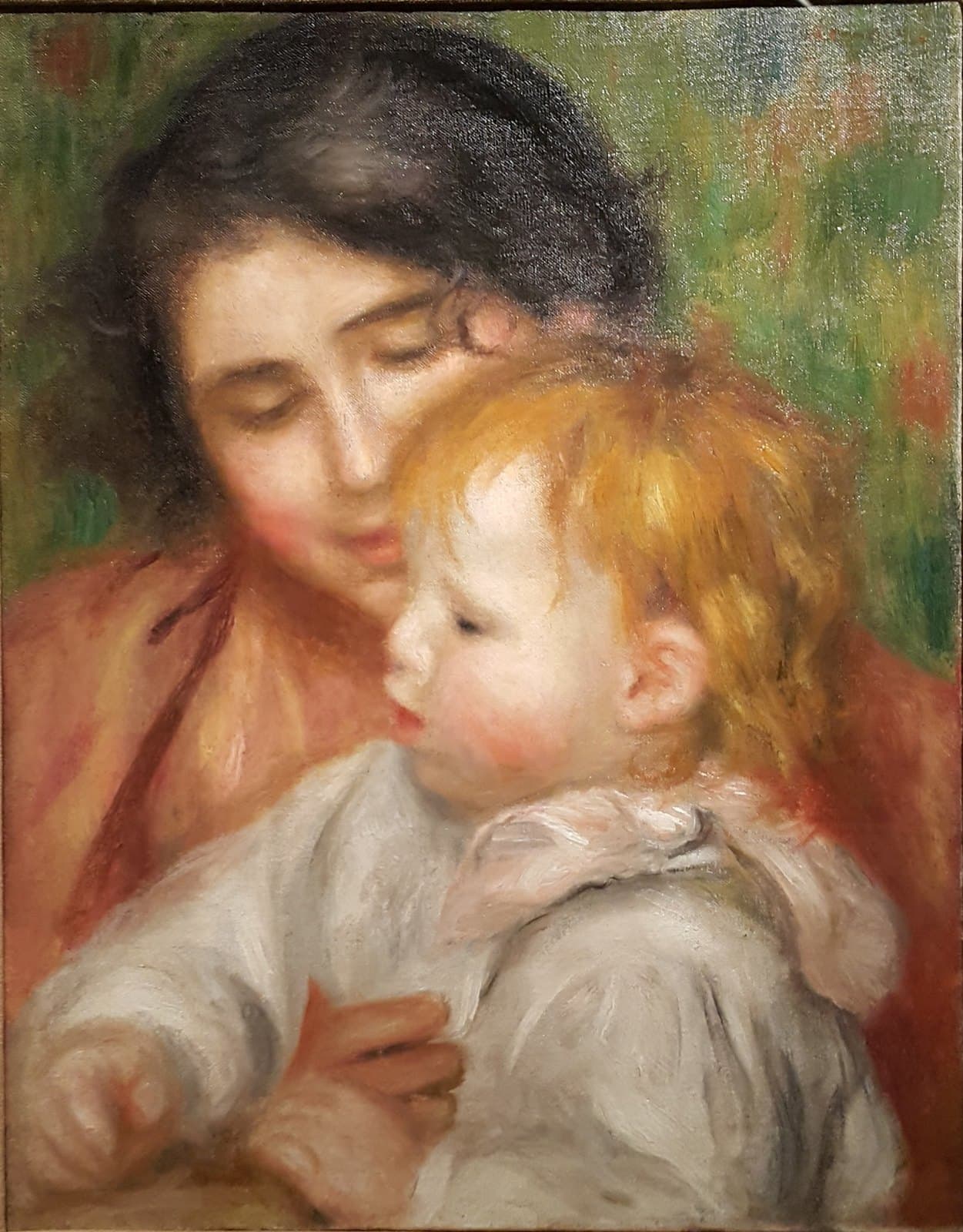 Renoir's painting of Gabrielle Renard holding the infant Jean Renoir on her lap, the child reaching toward toys on a table