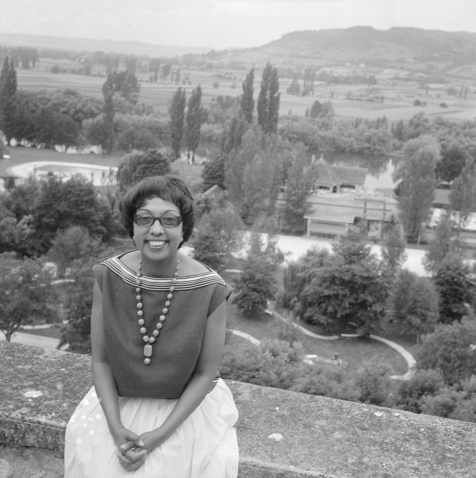 Josephine Baker in the garden at Château des Milandes in 1961, smiling in a patterned summer dress