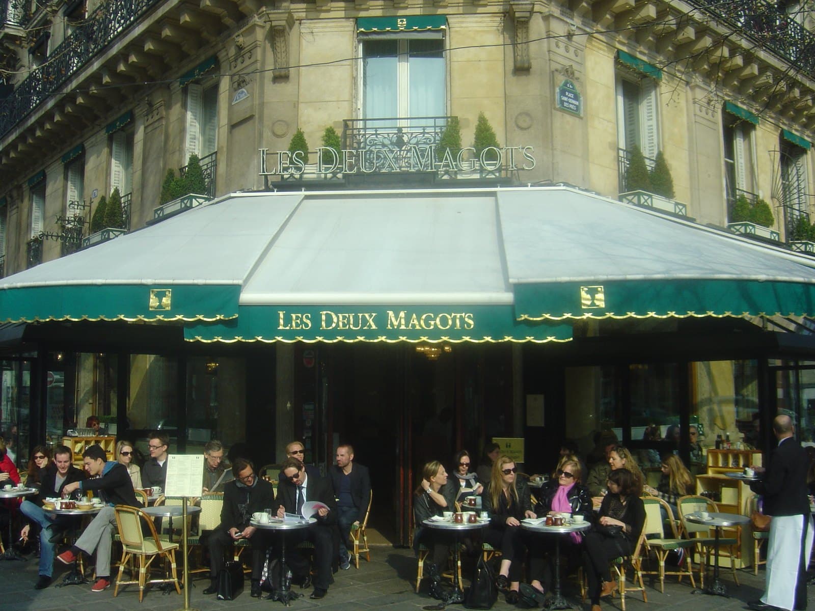 The corner frontage and terrace of Les Deux Magots on the boulevard Saint-Germain