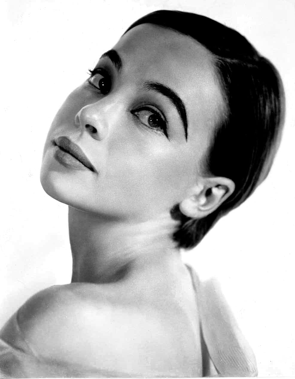Black-and-white studio portrait of Leslie Caron in the 1960s, looking toward the camera