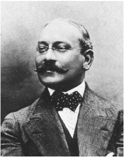 Louis Feuillade in a dark suit and mustache, facing the camera