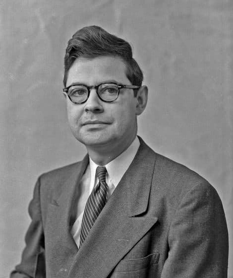 Milton Hindus as a young professor, in round glasses, striped tie, and a double-breasted suit.