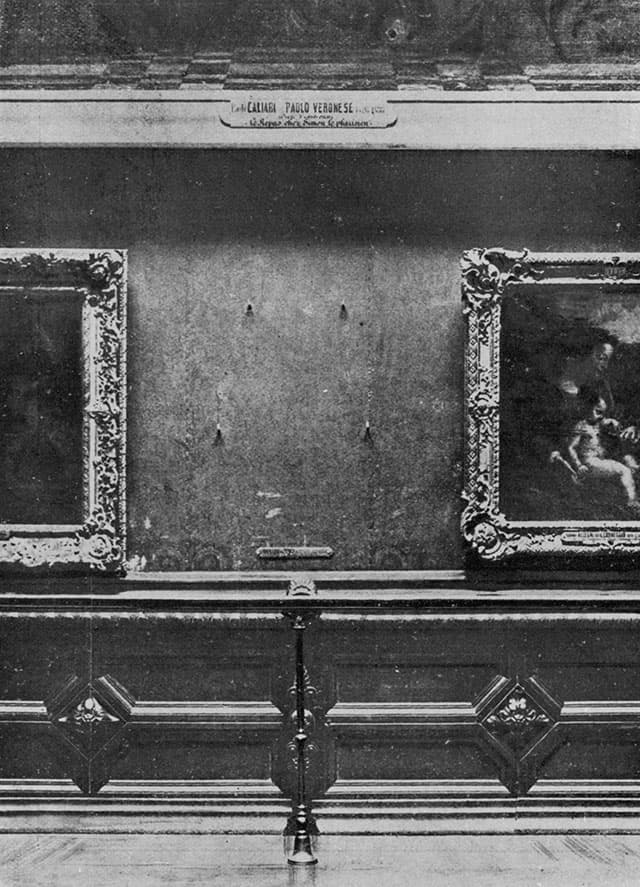 The Mona Lisa's empty place on a crowded wall in the Louvre's Salon Carré after the painting was stolen in August 1911