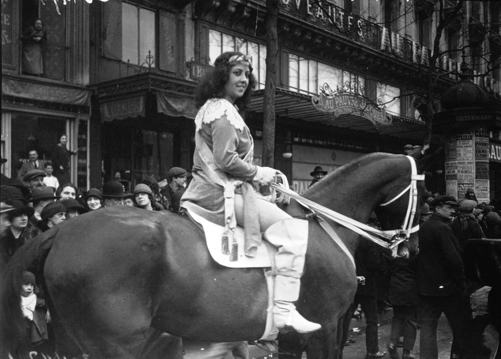 Musidora on horseback at the 1926 Paris Mi-Carême carnival, in costume, surrounded by crowds