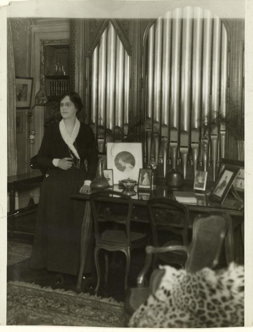 Nadia Boulanger seated at home beside a piano in 1924