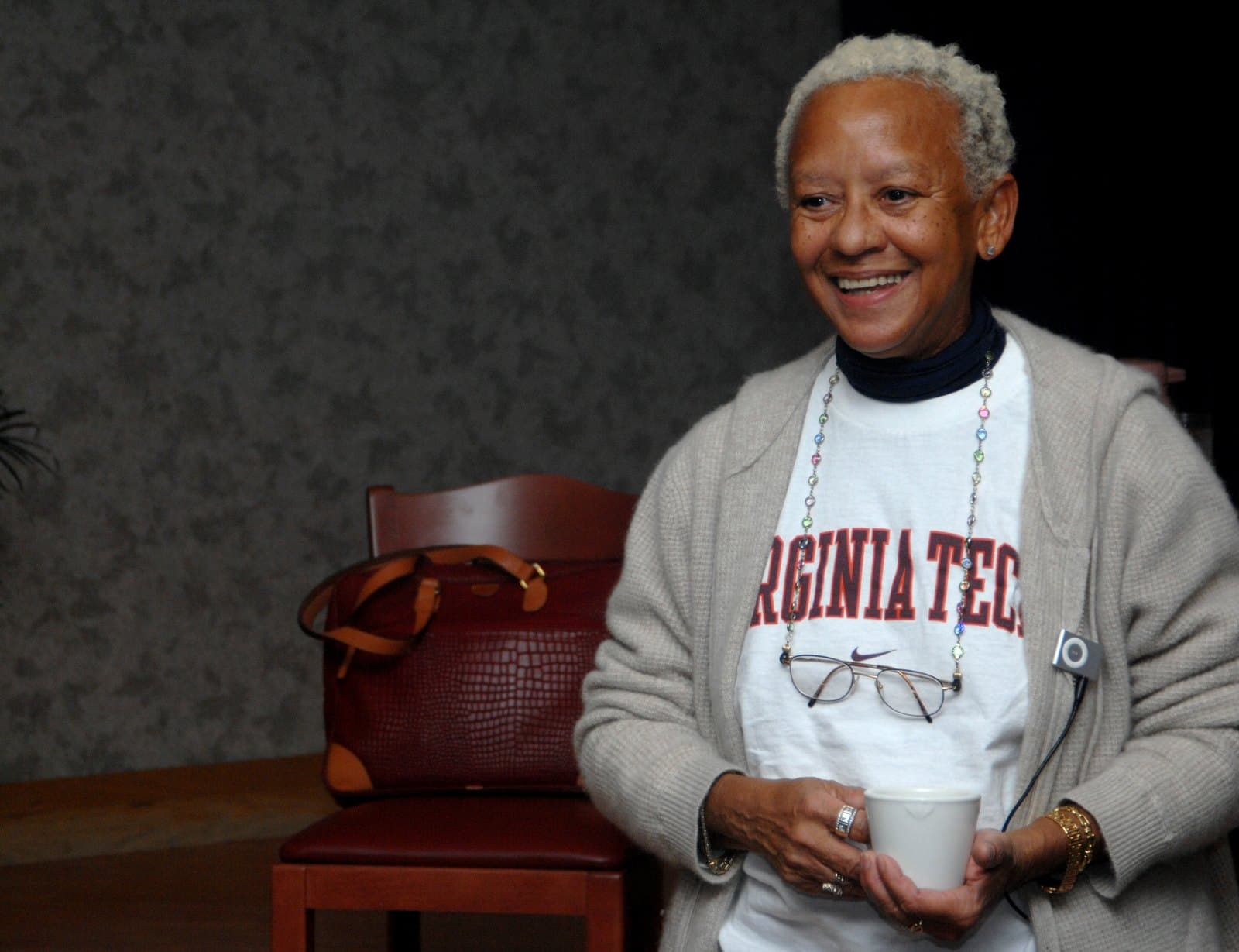 Nikki Giovanni seated at a table at Mountain Home Air Force Base in 2008, speaking with an attentive expression