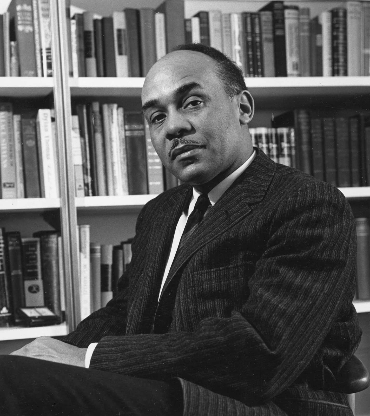 Ralph Ellison seated for a portrait photograph in 1961