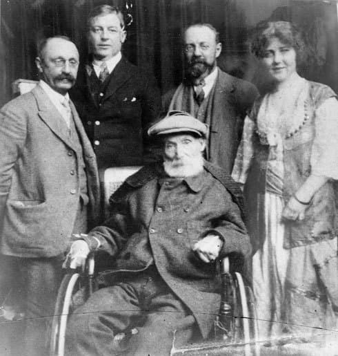 The elderly Renoir seated outdoors at Cagnes-sur-Mer surrounded by four standing visitors, among them Henri Matisse