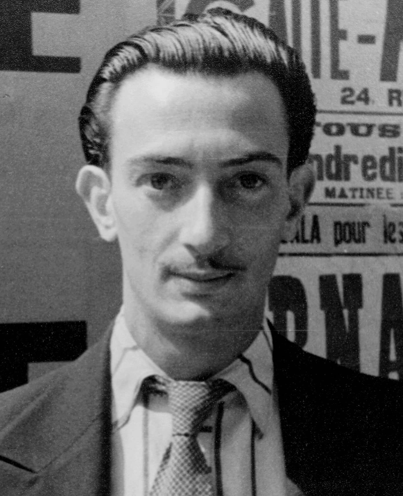 Salvador Dalí in Paris, 1934: slicked hair and the famous mustache still modest, in jacket and patterned tie, photographed by Carl Van Vechten