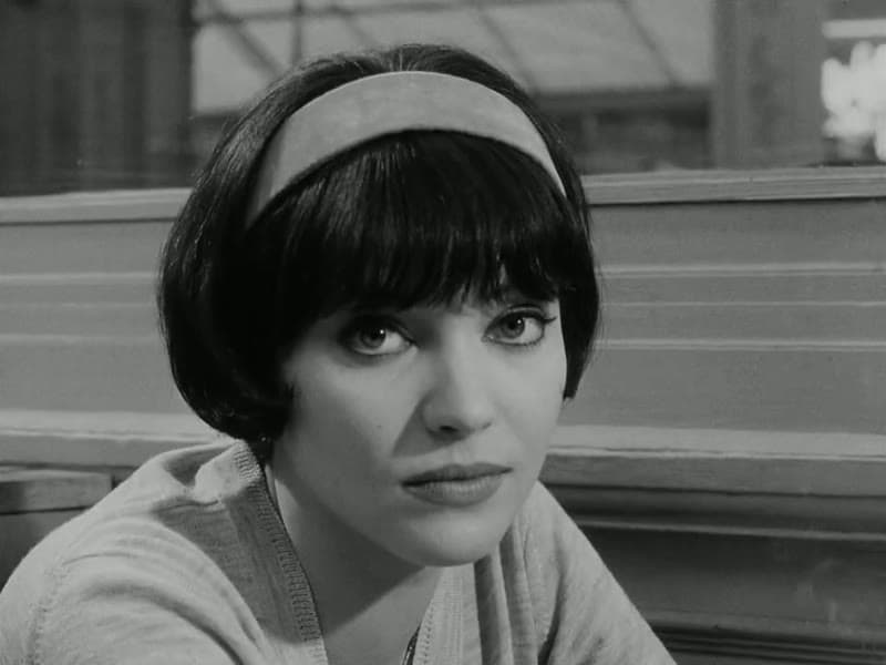 Anna Karina as Nana in frontal close-up, wearing a headband over her dark bob