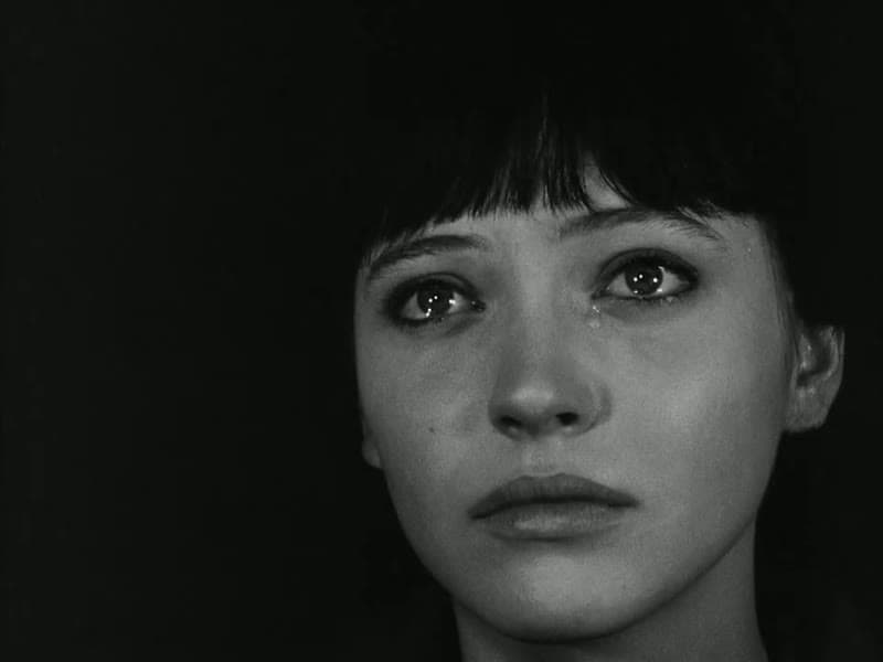 Anna Karina as Nana in close-up, her eyes filled with tears
