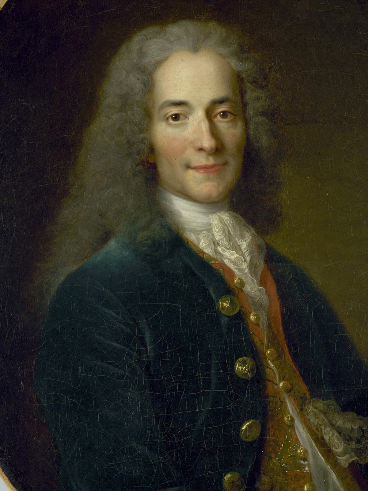 Young Voltaire in a blue coat with a lace collar, holding a black tricorne hat in a painted portrait