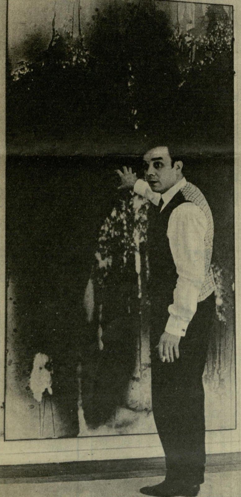 Yves Klein standing before one of his monochrome canvases in 1962
