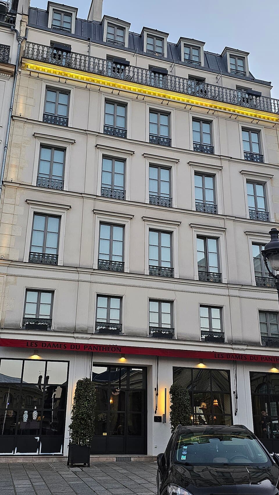 The stone façade and entrance of Hôtel Les Dames du Panthéon.