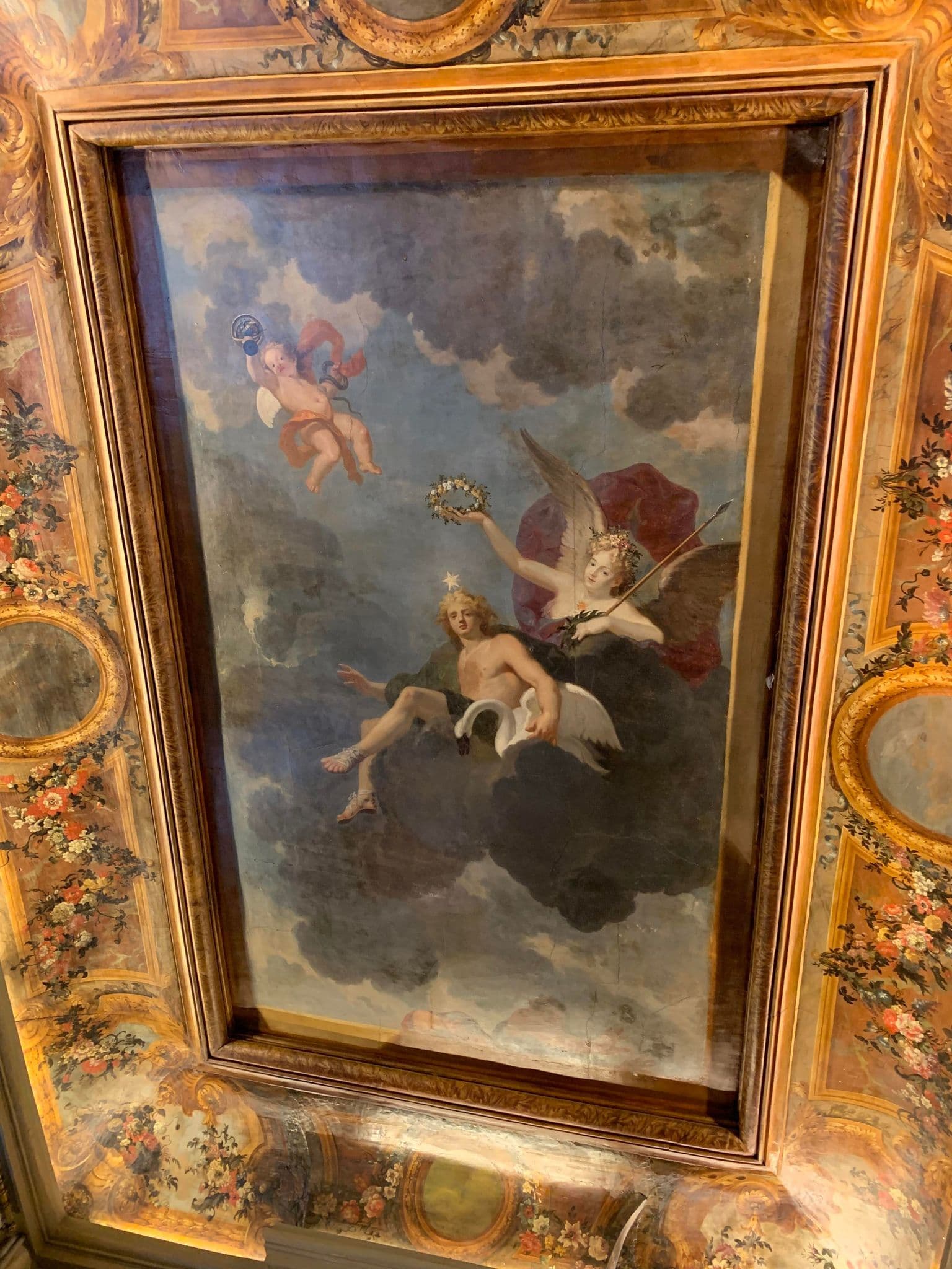 Painted ceiling from the historic Hôtel Gittard, with mythological figures inside a gilded border.