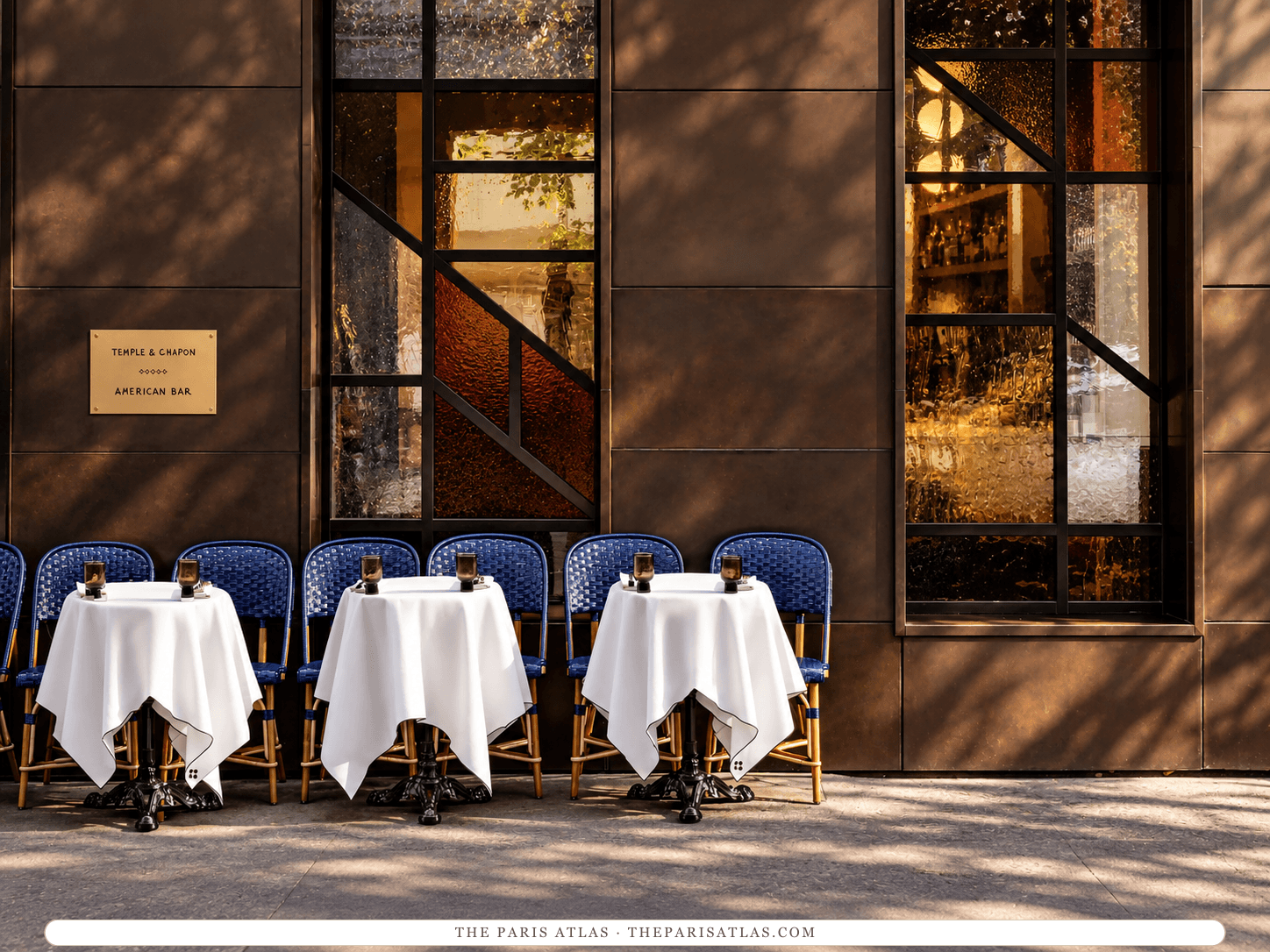 AI-generated illustration of the street terrace at Experimental Marais: small round tables with white cloths and blue rattan chairs in front of a bronze-toned façade, with a brass plaque for Temple & Chapon and the American Bar.